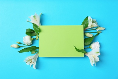 Photo of Empty greeting card with flowers on color background, top view. Space for text