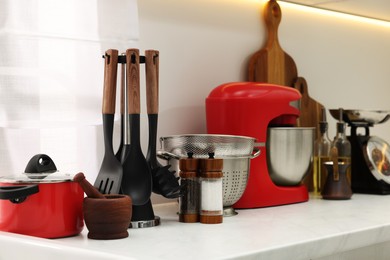 Photo of Set of different utensils on countertop in kitchen