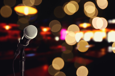 Image of Modern microphone in karaoke club. Space for text