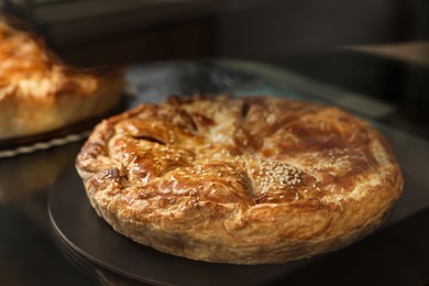 Photo of Delicious pie with tasty filling on counter in bakery shop, closeup. Space for text