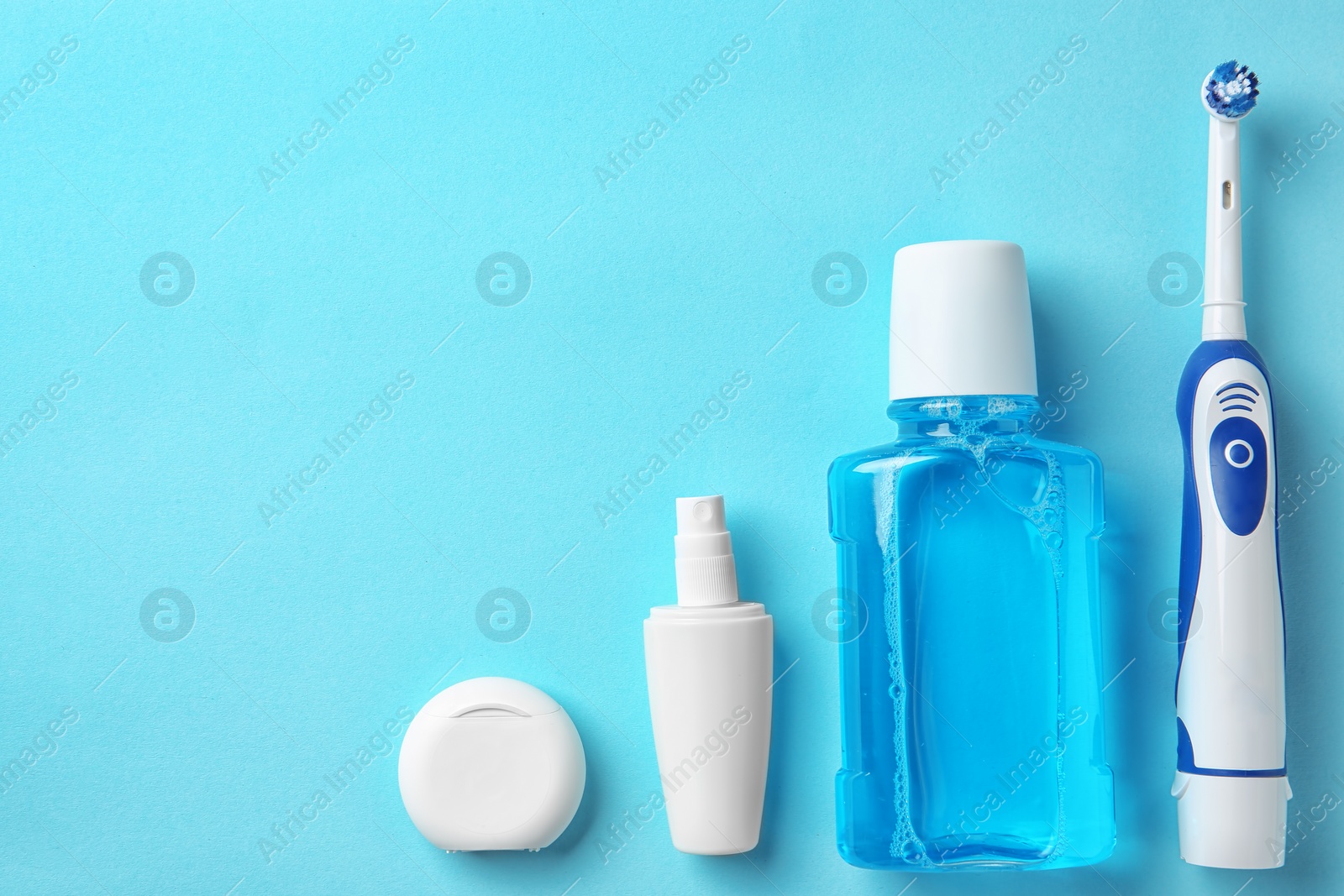 Photo of Flat lay composition with electric toothbrush and oral hygiene products on color background