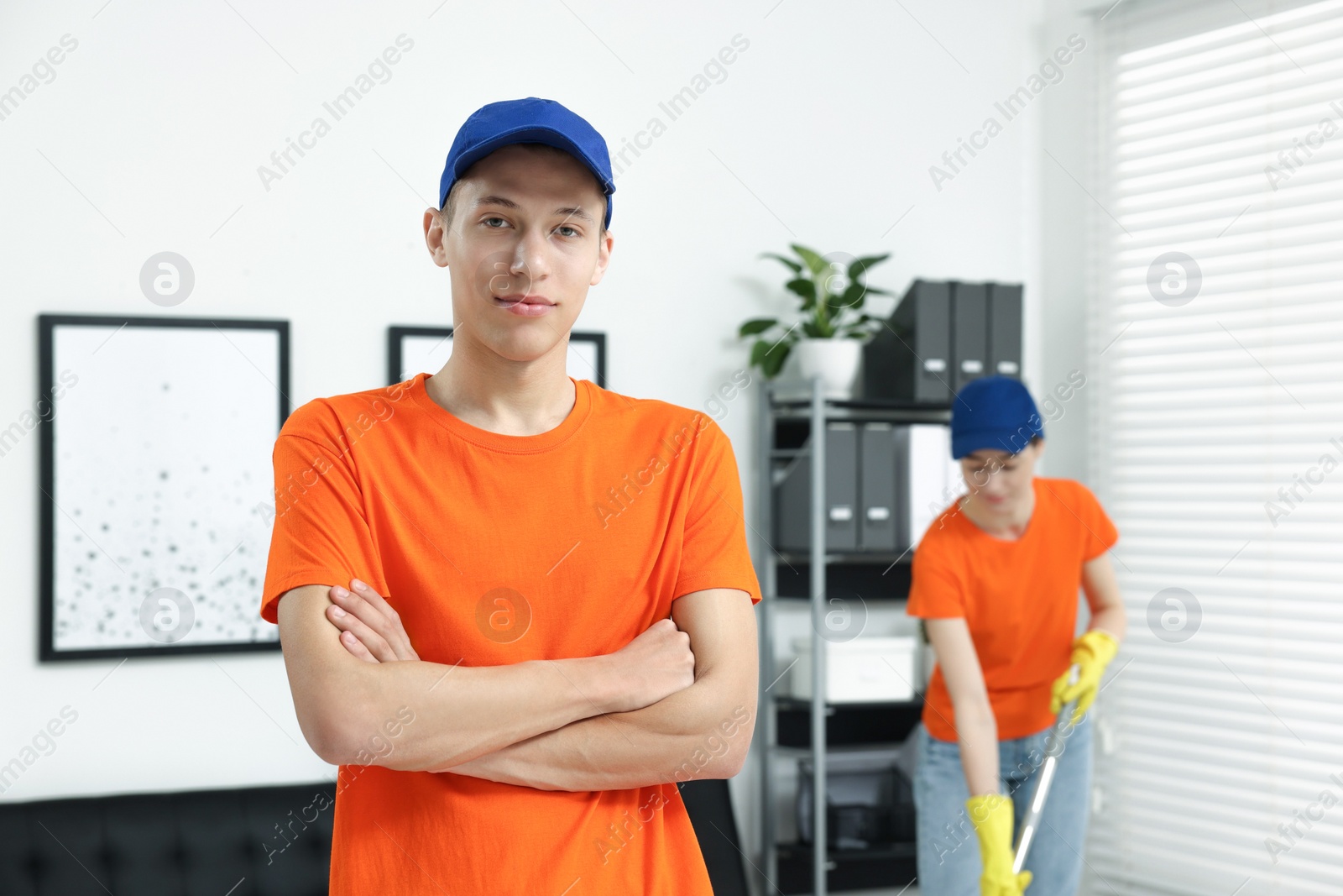 Photo of Portrait of cleaning service worker in office, selective focus