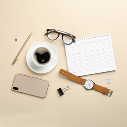 Photo of Flat lay composition with calendar on beige background