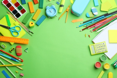Photo of Different bright school stationery on light green background, flat lay. Space for text