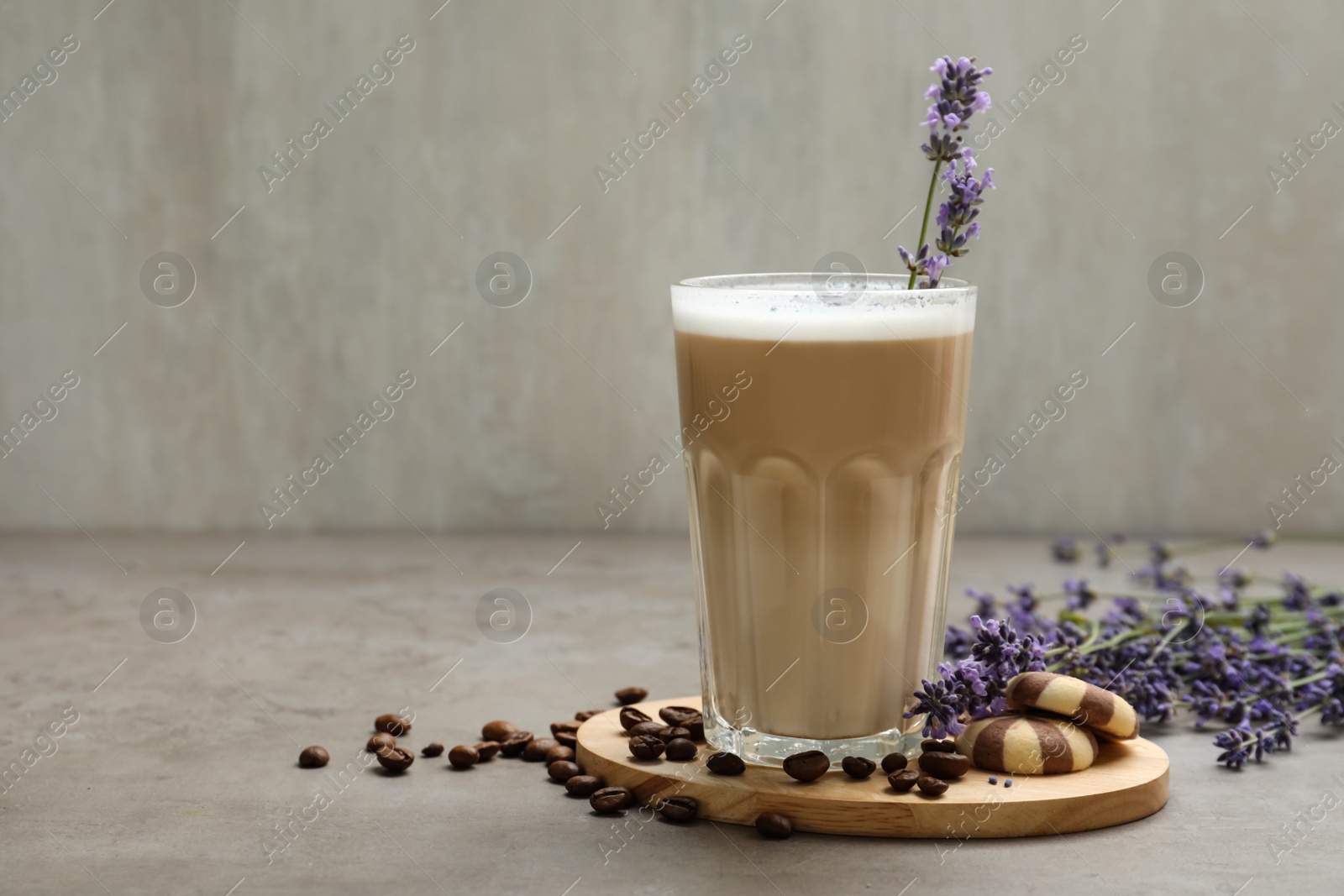 Photo of Delicious coffee with lavender and cookies on grey table. Space for text