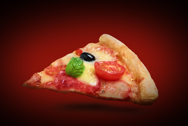 Image of Slice of hot tasty pizza Diablo on dark red background. Image for menu or poster