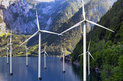 Floating wind turbines installed in water near mountains. Alternative energy source