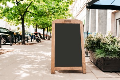 Photo of Blank advertising board on city street. Space for design