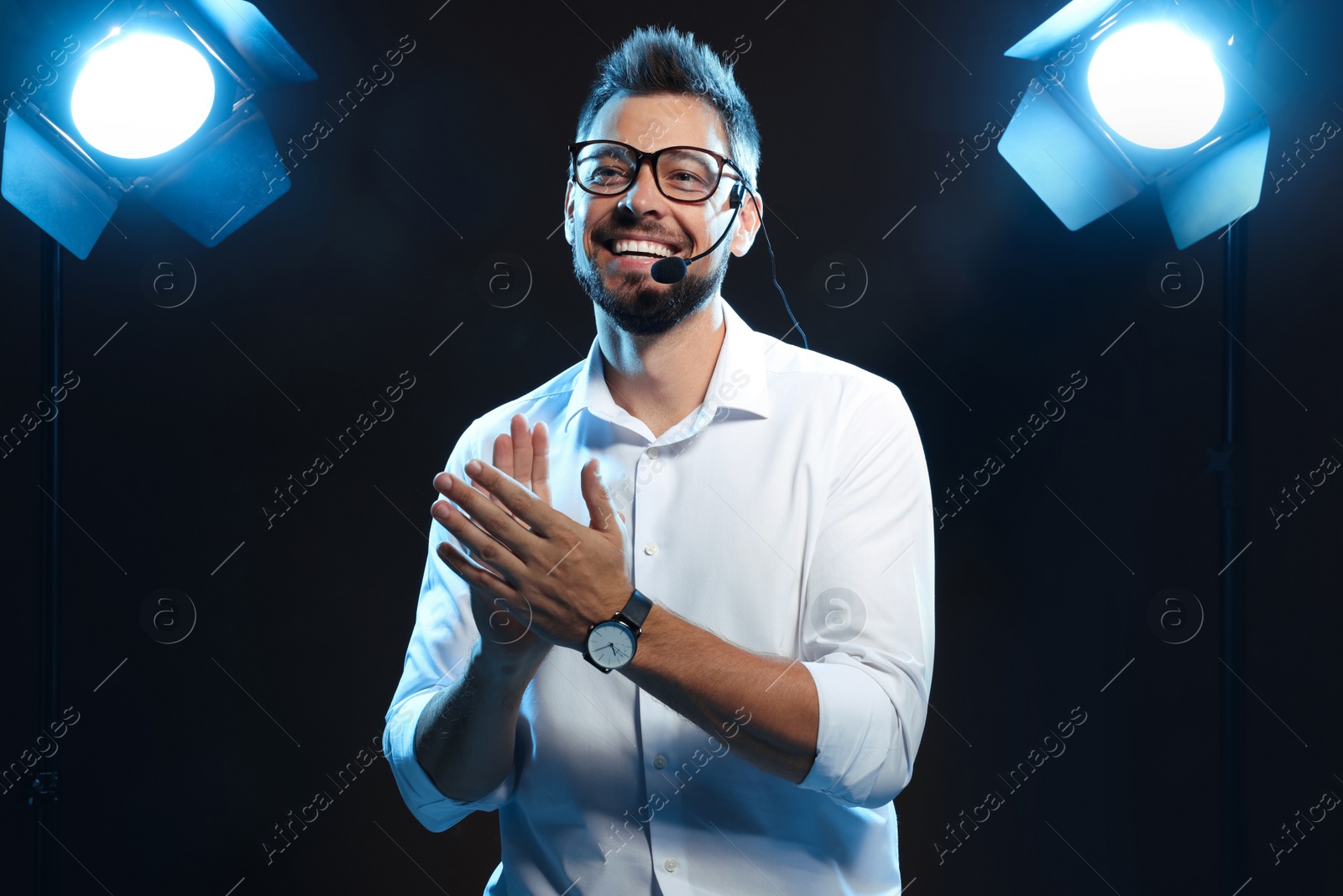 Photo of Motivational speaker with headset performing on stage