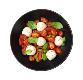 Photo of Bowl of tasty salad Caprese with tomatoes, mozzarella balls and basil isolated on white, top view