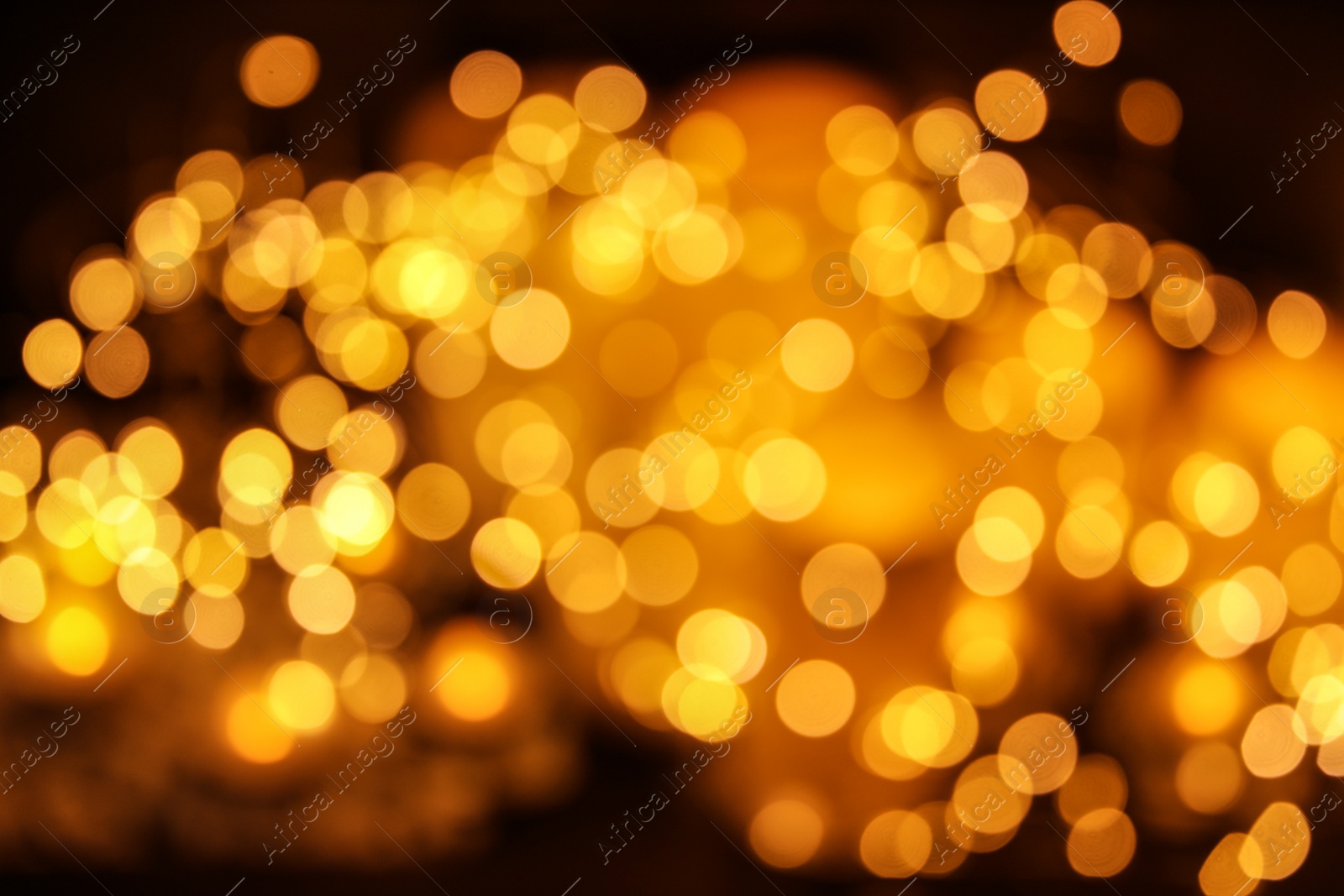 Photo of Gold glitter with bokeh effect on dark background