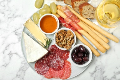 Photo of Flat lay composition with wine and snacks on marble background