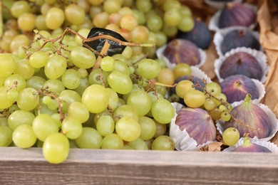 Fresh ripe fruits in wooden crate at market, closeup