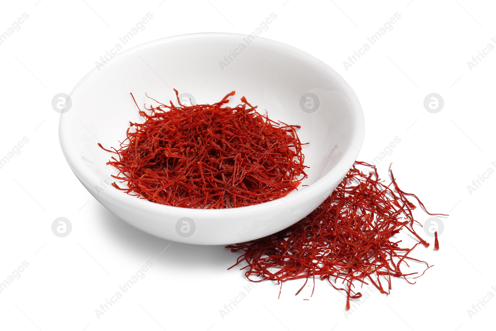 Photo of Aromatic saffron in bowl isolated on white