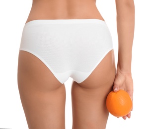 Photo of Closeup view of slim woman in underwear with orange on white background. Cellulite problem concept