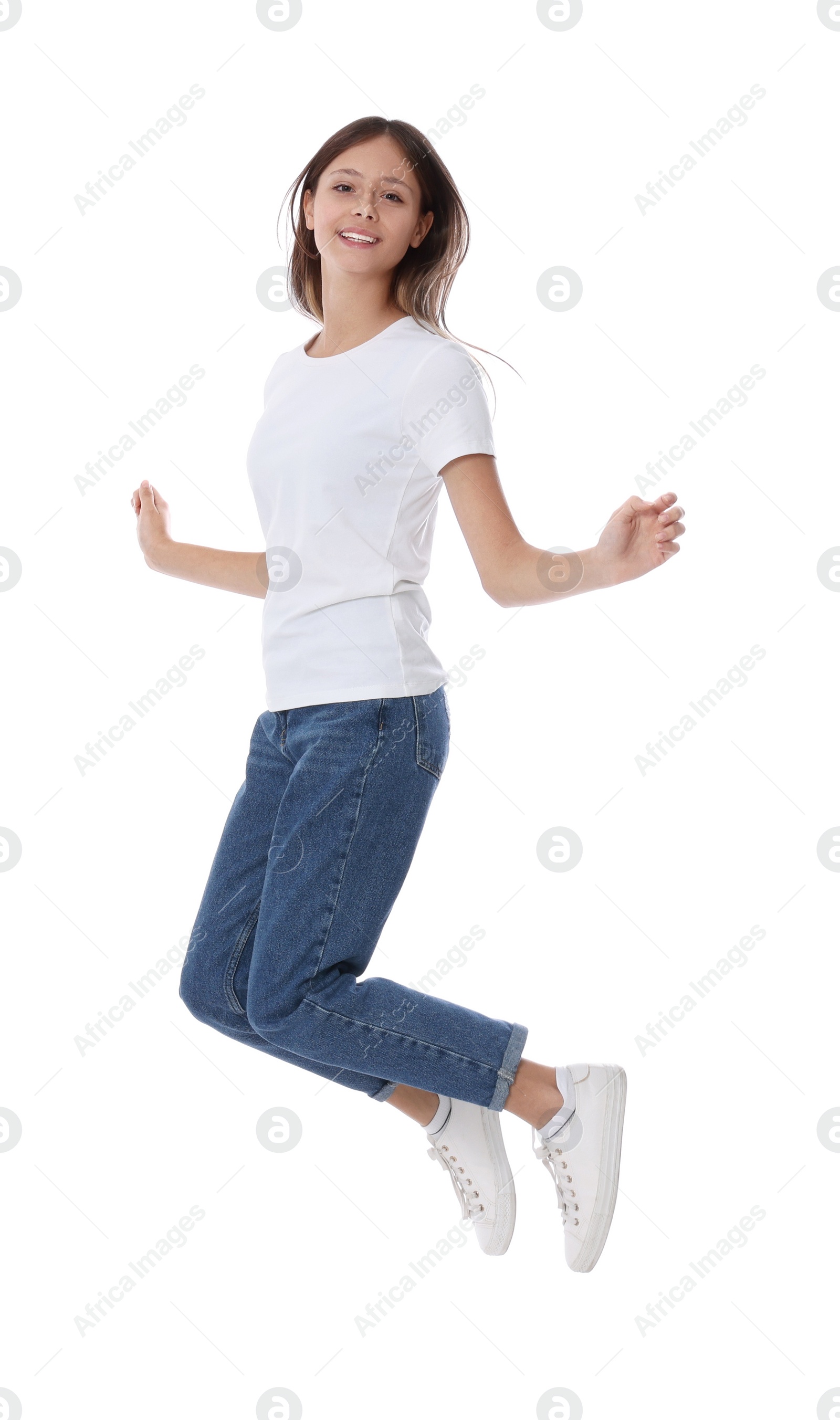 Photo of Teenage girl in casual clothes jumping on white background