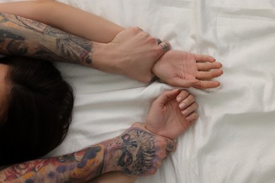 Photo of Passionate couple having sex on bed, closeup of hands