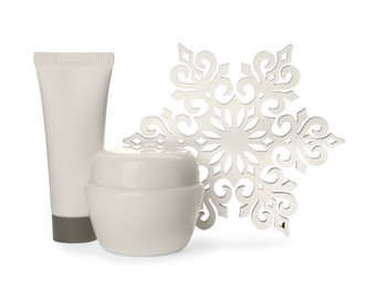 Photo of Cosmetic products and snowflake on white background. Winter skin care