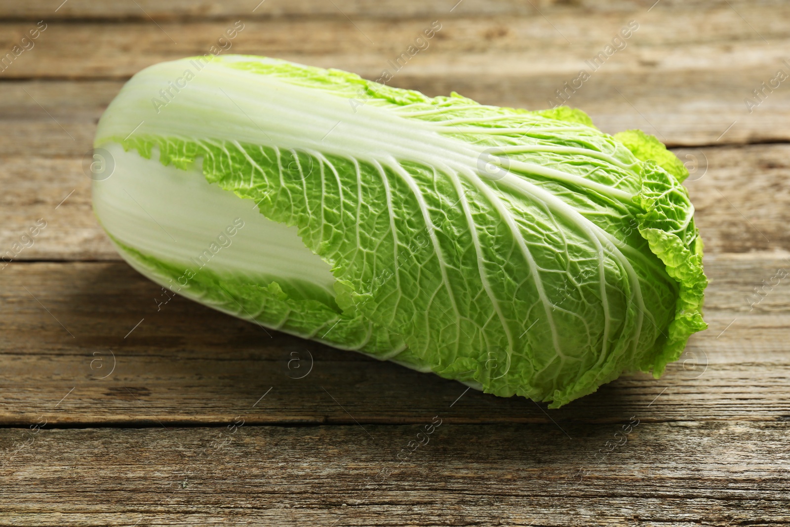 Photo of Fresh ripe Chinese cabbage on wooden table