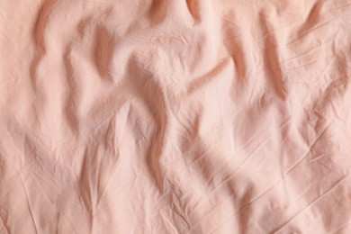 Photo of Crumpled pink fabric as background, top view