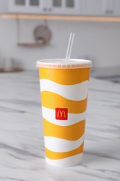 Photo of MYKOLAIV, UKRAINE - AUGUST 12, 2021: Cold McDonald's drink on marble table in kitchen