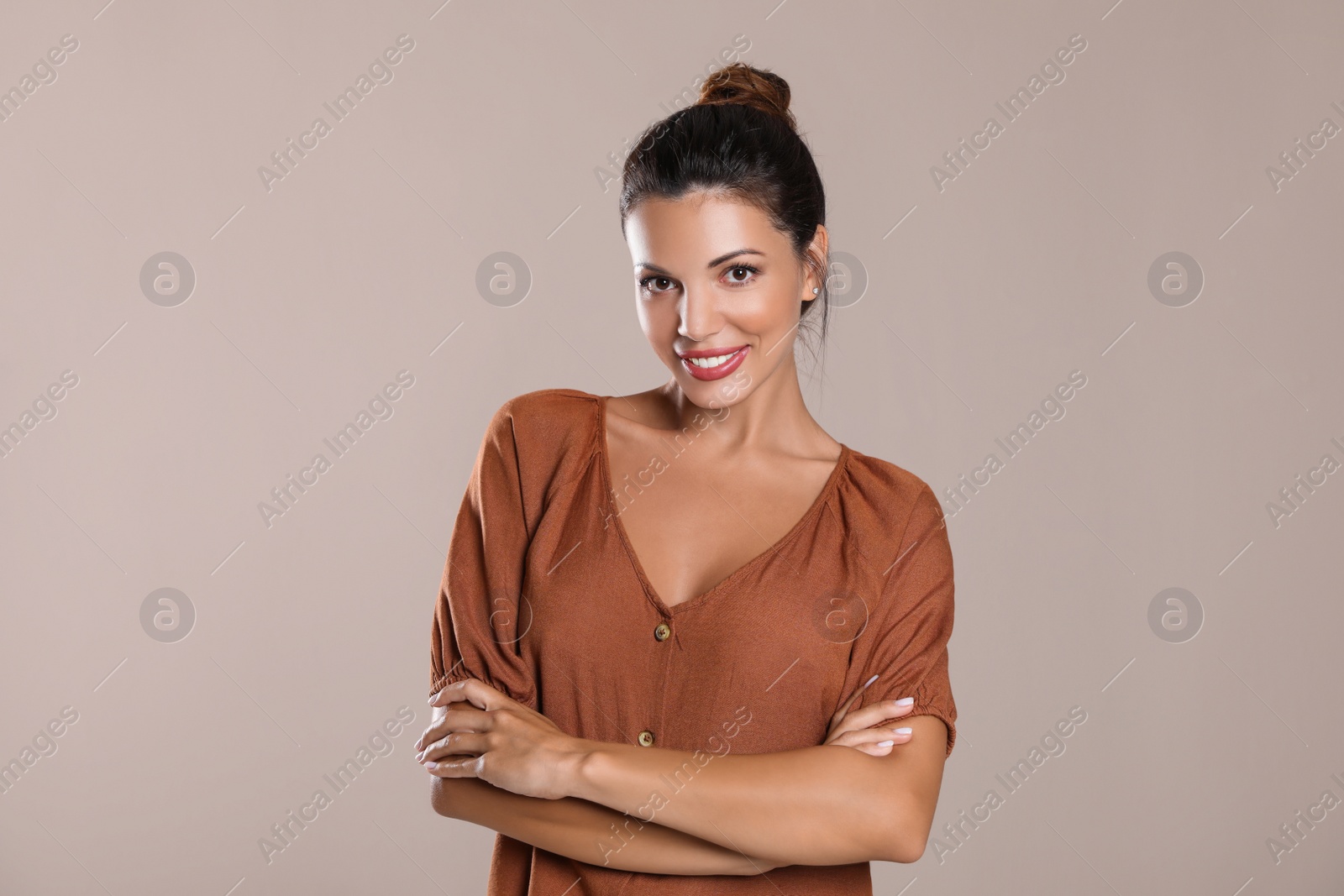 Photo of Portrait of beautiful woman on light brown background