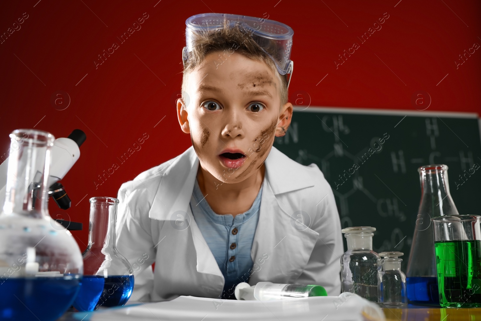 Photo of Emotional child in laboratory after explosion. Dangerous experiment