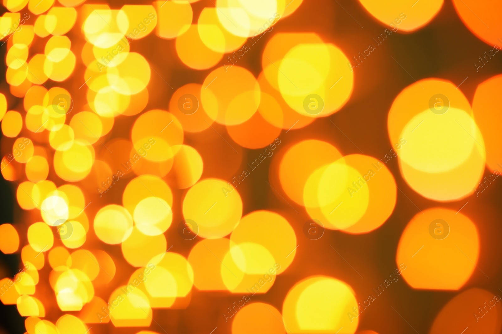 Photo of Beautiful gold lights on dark background. Bokeh effect