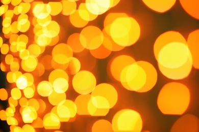 Photo of Beautiful gold lights on dark background. Bokeh effect