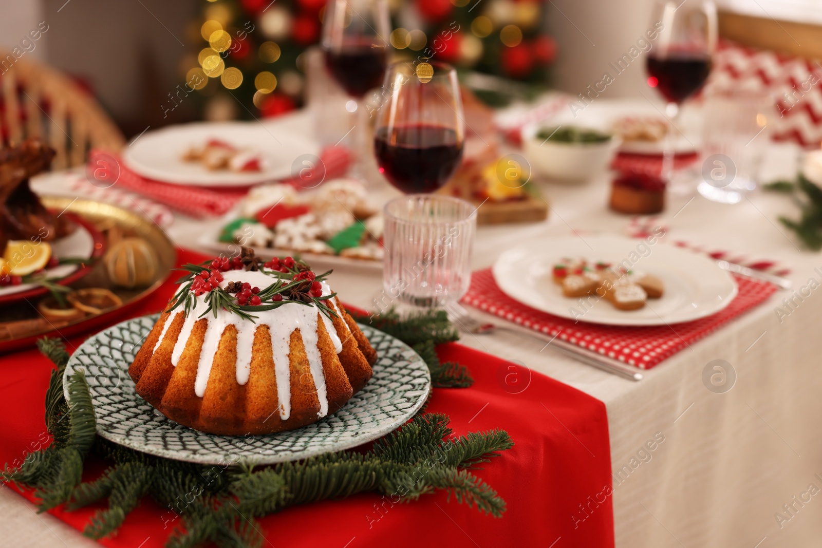 Photo of Festive dinner with delicious cake served on table indoors, space for text. Christmas Eve celebration