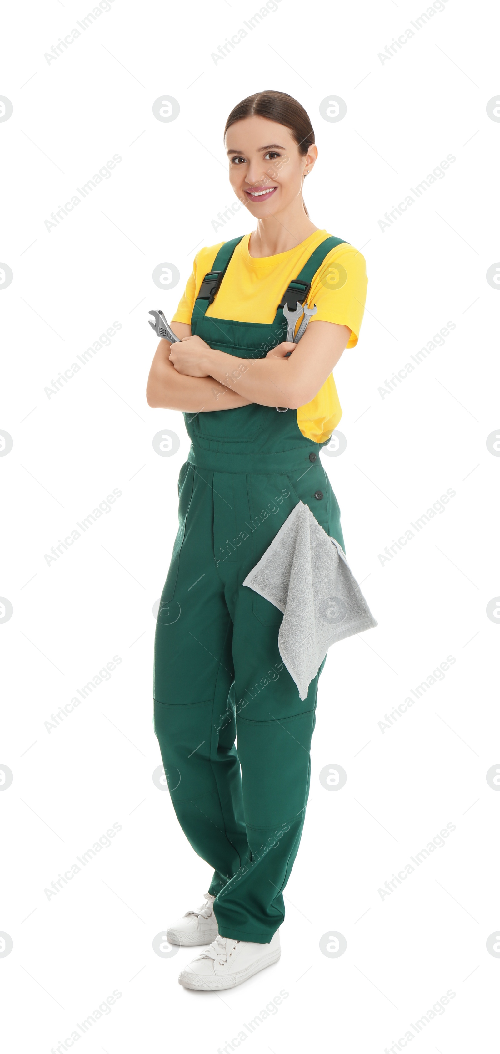 Photo of Full length portrait of professional auto mechanic with wrenches and rag on white background