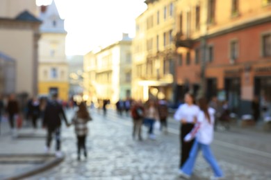 Photo of Blurred view of people walking on city street