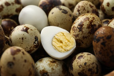 Photo of Heap of unpeeled and peeled hard boiled quail eggs as background, closeup