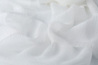 Photo of Beautiful white tulle fabric as background, closeup