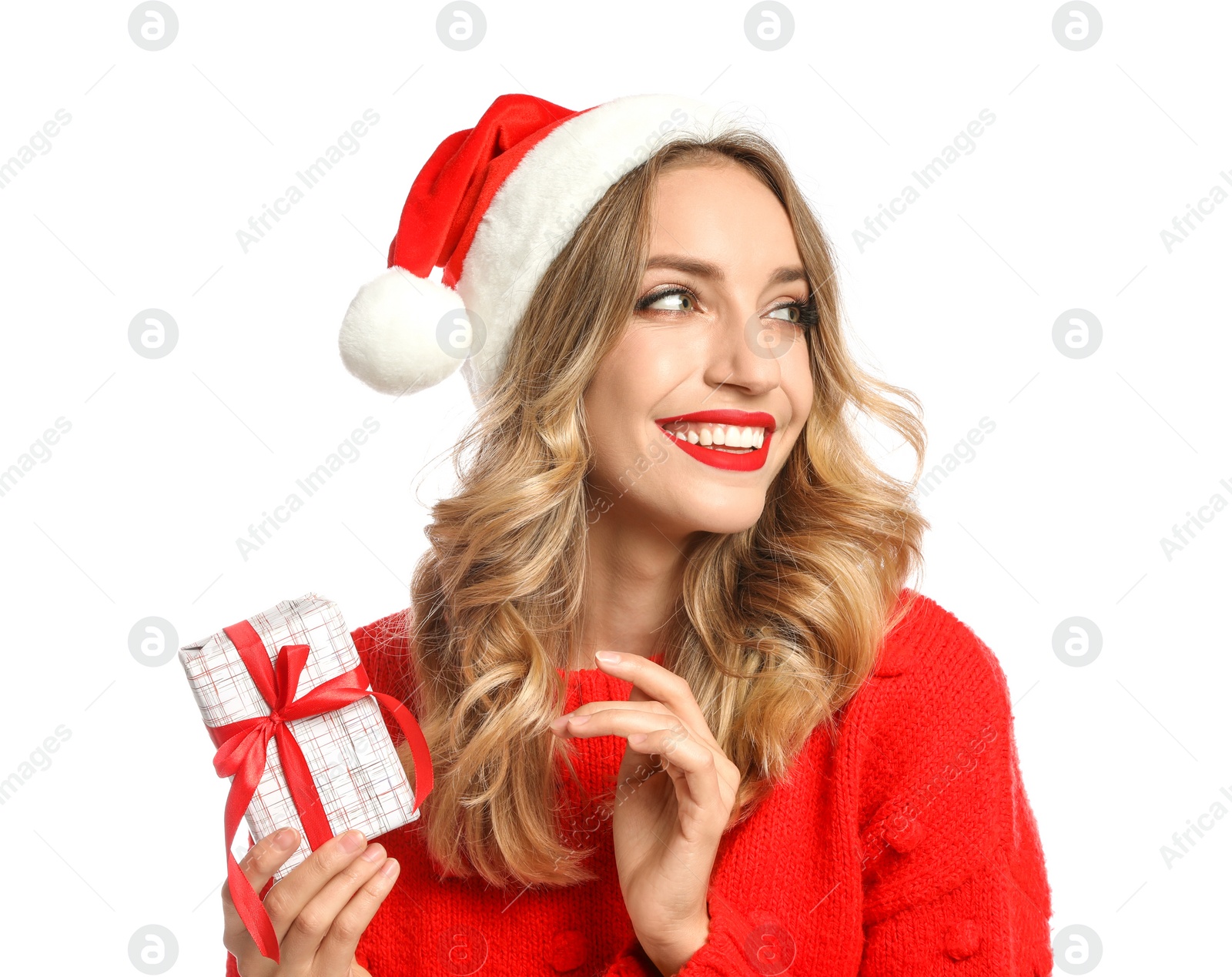 Photo of Happy young woman wearing Santa hat with Christmas gift on white background