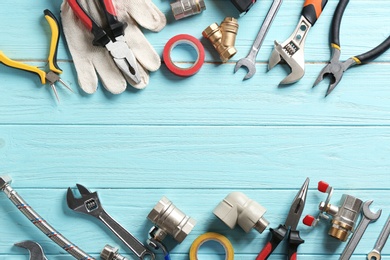 Photo of Flat lay composition with plumber's tools and space for text on wooden background