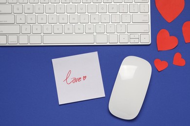 Photo of Long-distance relationship concept. Computer mouse, keyboard, love note and paper hearts on blue background, flat lay