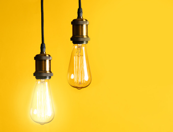 Image of Idea concept. Light bulbs on yellow background, space for text 