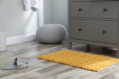 Mat near chest of drawers in bathroom