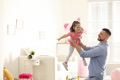 Father playing with his child at home