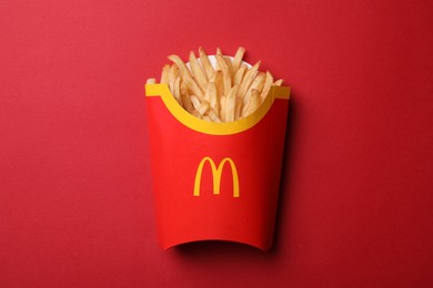 MYKOLAIV, UKRAINE - AUGUST 12, 2021: Big portion of McDonald's French fries on red background, top view