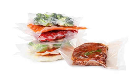 Photo of Vacuum packs with different food products on white background