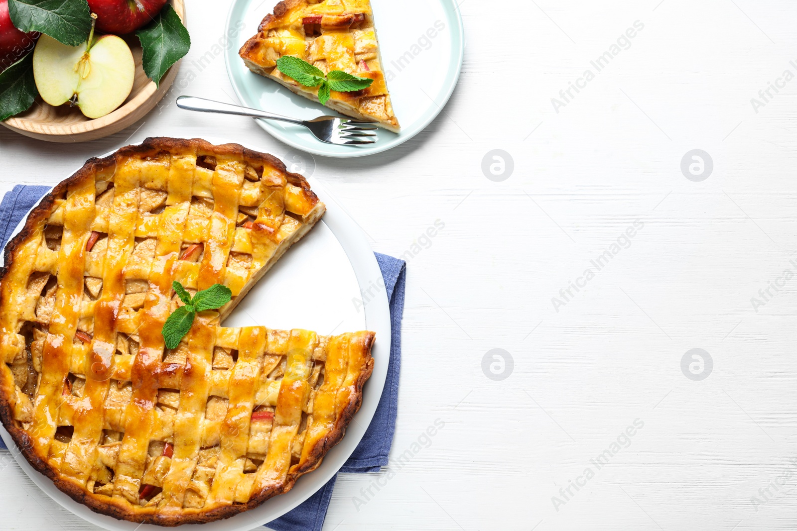 Photo of Traditional apple pie on white wooden table, flat lay. Space for text