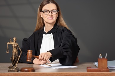 Photo of Judge striking mallet at wooden table indoors