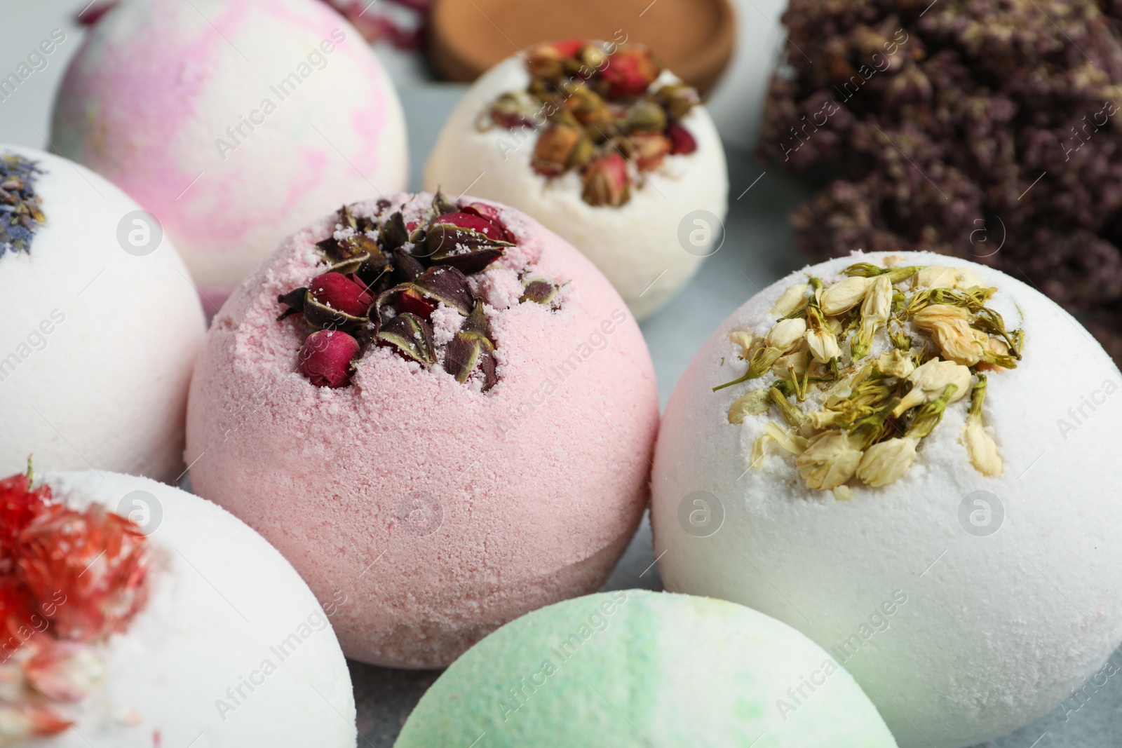 Photo of Plate with different bath bombs on table, closeup