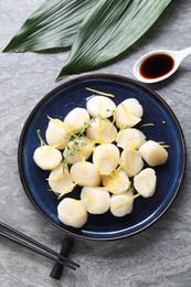 Photo of Raw scallops with thyme and lemon zest served on grey marble table, flat lay