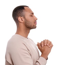 Photo of African American man with clasped hands praying to God on white background