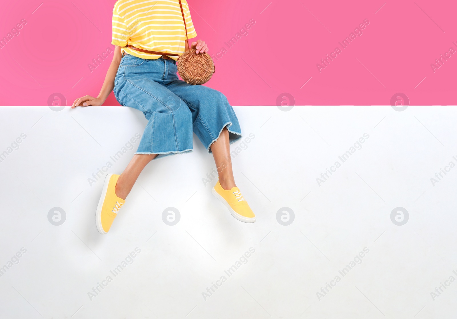 Photo of Woman wearing stylish shoes on color background, closeup