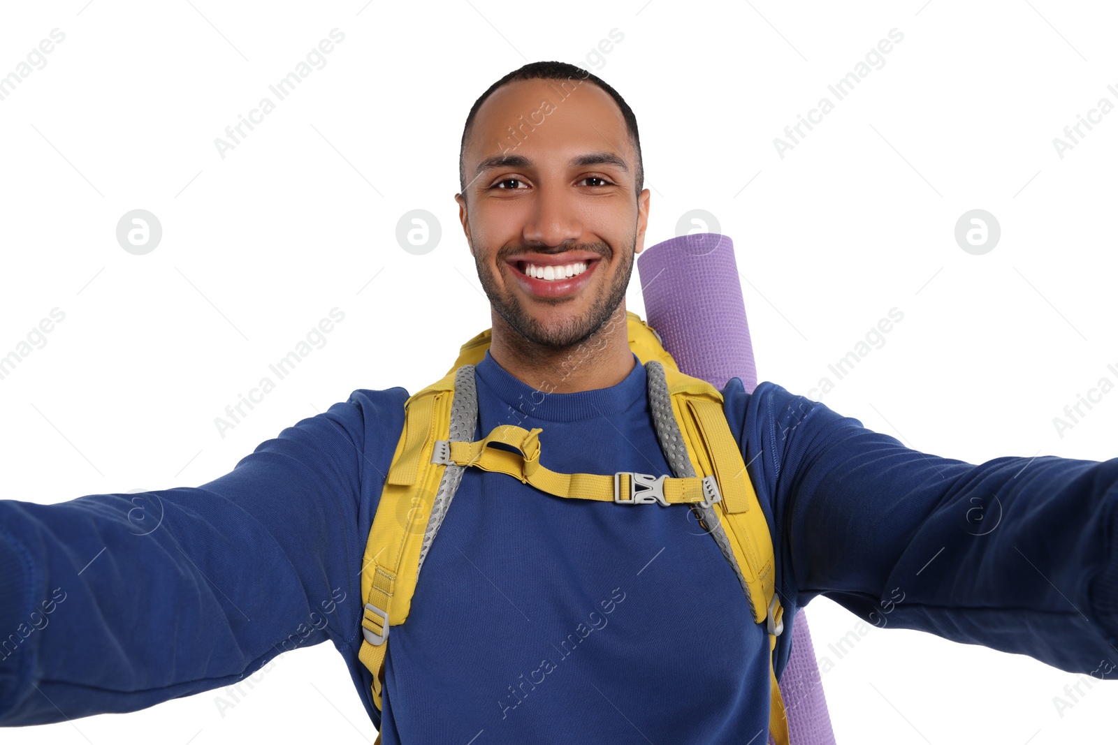 Photo of Happy tourist with backpack taking selfie on white background