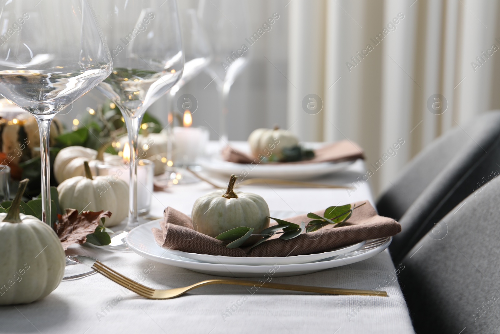 Photo of Beautiful autumn table setting. Plates, cutlery, glasses, pumpkins and floral decor